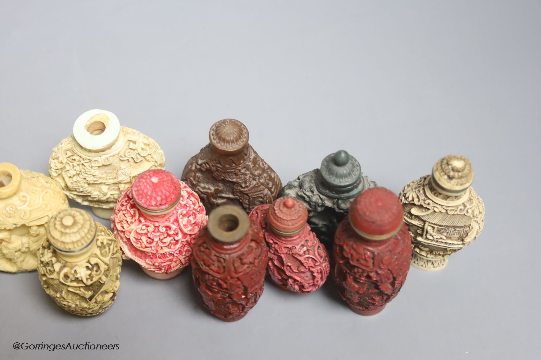 A large Chinese 20th century carved snuff bottle and smaller snuff bottles